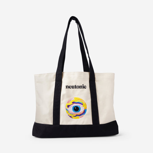 Cream canvas tote bag with black straps and base, featuring colorful nootropics eye design and "neutonic" text on front. - Neutonic - Tote Bag