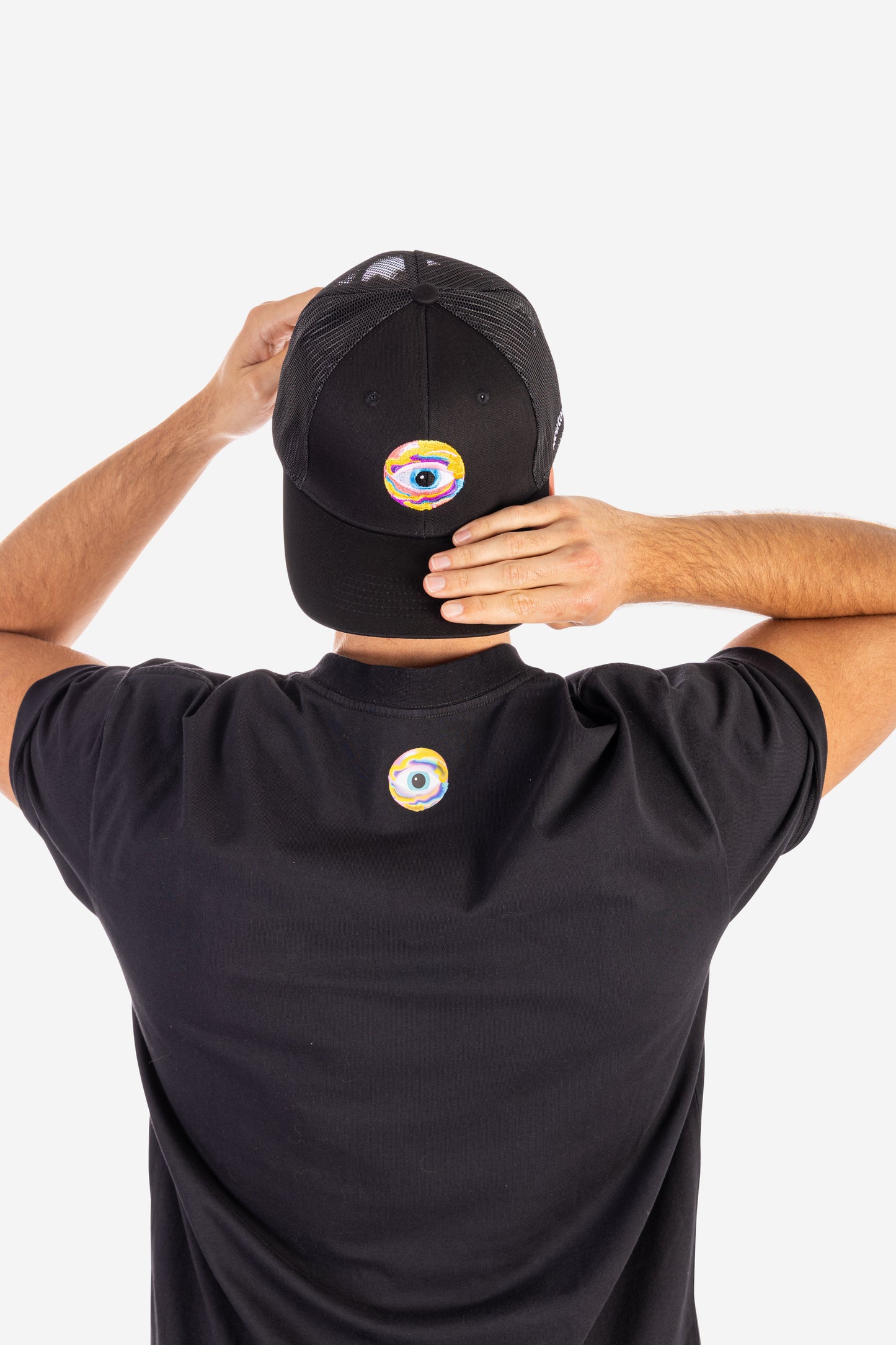 Black trucker cap with colorful eye graphic and subtle nootropics logo on back of matching black t-shirt. - Neutonic - Trucker Cap - Eye