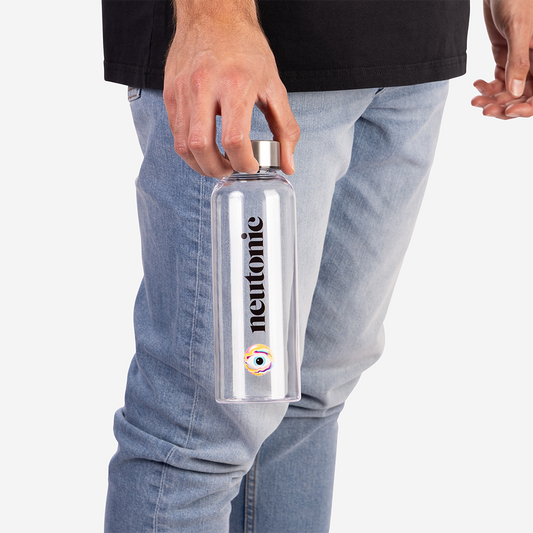 Clear plastic water bottle with silver cap and Nootropic logo held by person in jeans. - Neutonic - Water Bottle