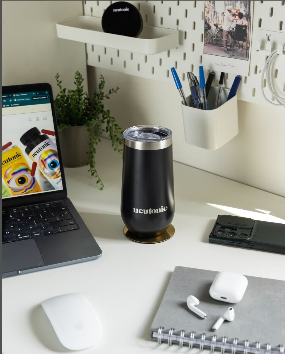 Black stainless steel tumbler with silver lid on white office desk, promoting nootropics. - Neutonic - Tumbler