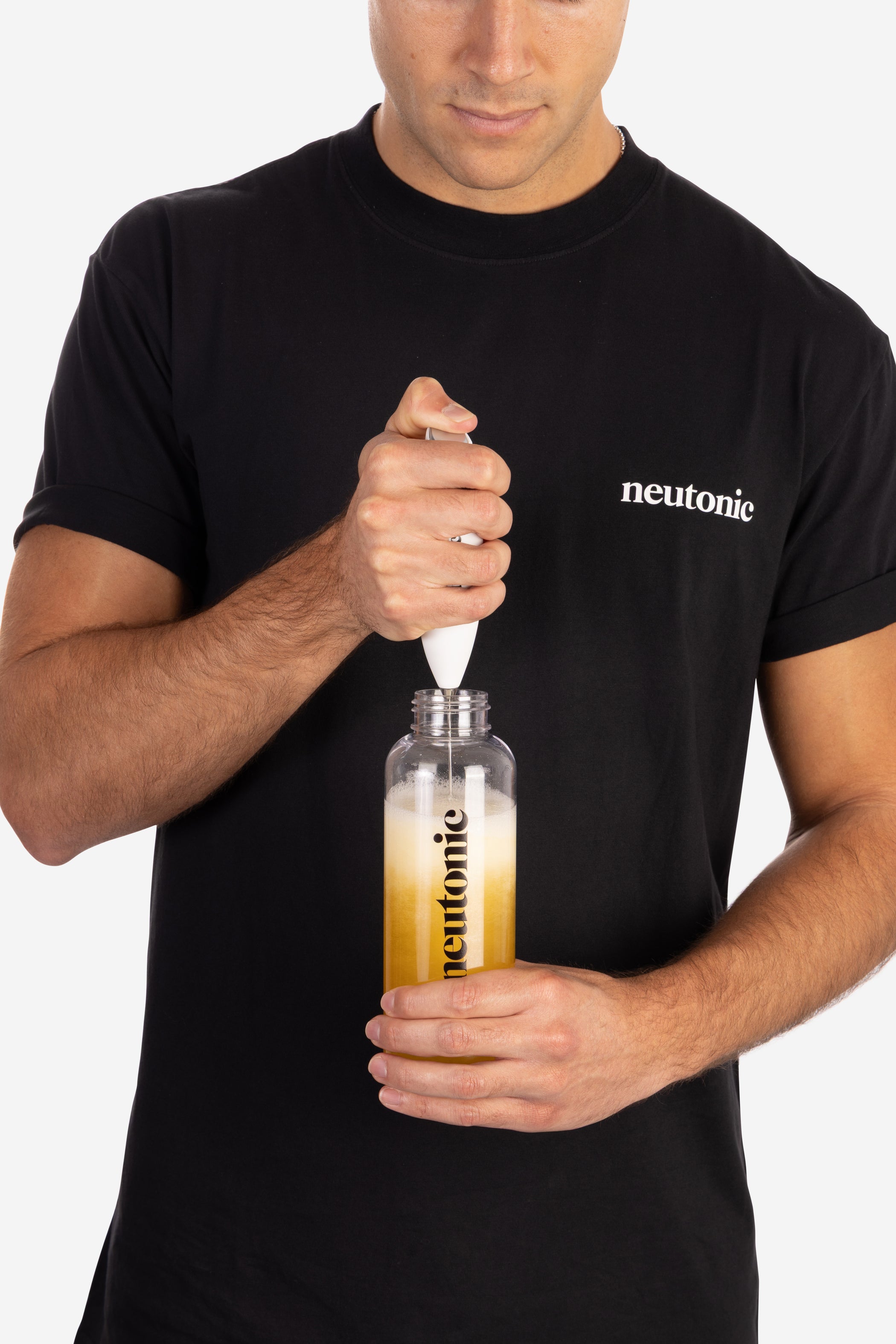 Handheld whisk mixing liquid in clear nootropics bottle held by person in black neutratee shirt. - Neutonic - Handheld Whisk