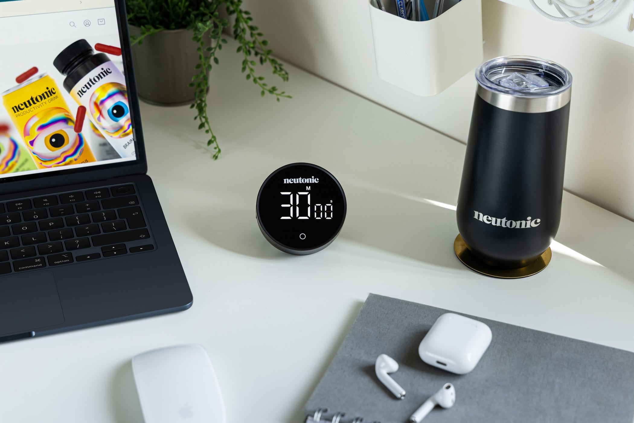 Compact black Focus Timer with digital countdown on white desk near laptop and nootropics bottle. - Neutonic - Focus Timer