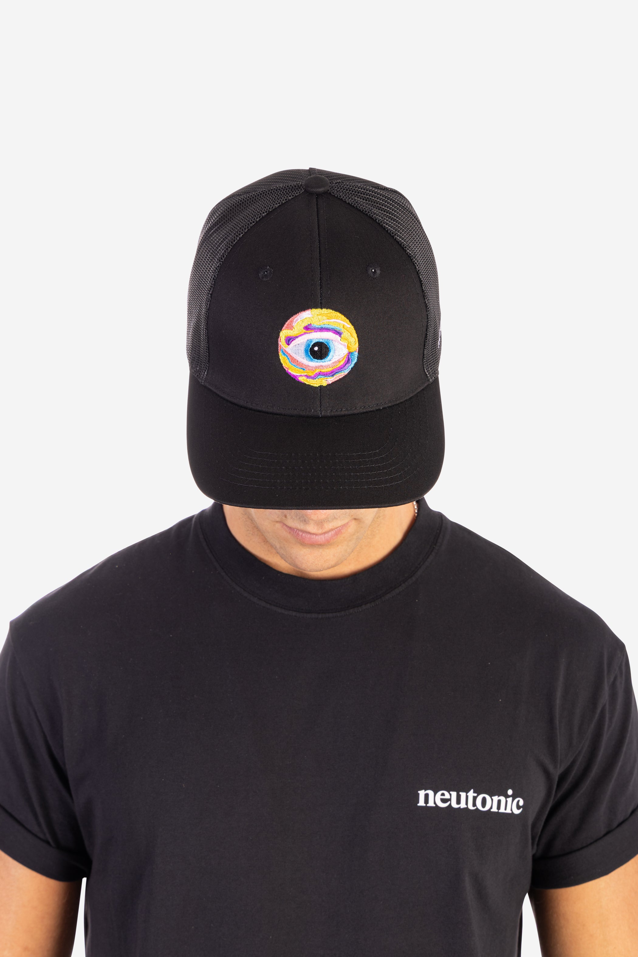 Black trucker cap with a colorful eye logo, worn with a black nootropics-themed t-shirt. - Neutonic - Trucker Cap - Eye