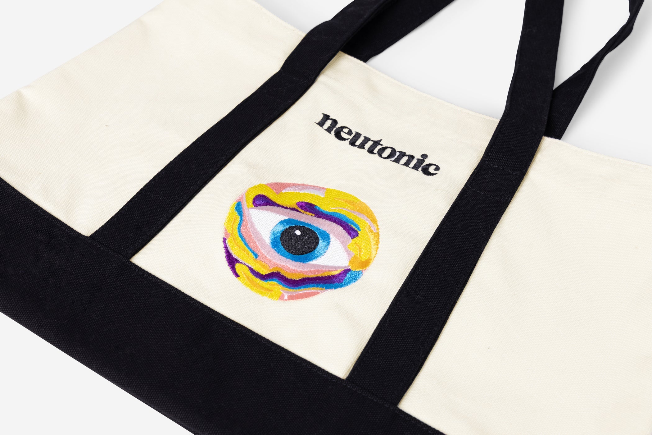 Canvas tote bag with black handles and colorful eye design featuring the word "neutonic" and nootropics theme. - Neutonic - Tote Bag